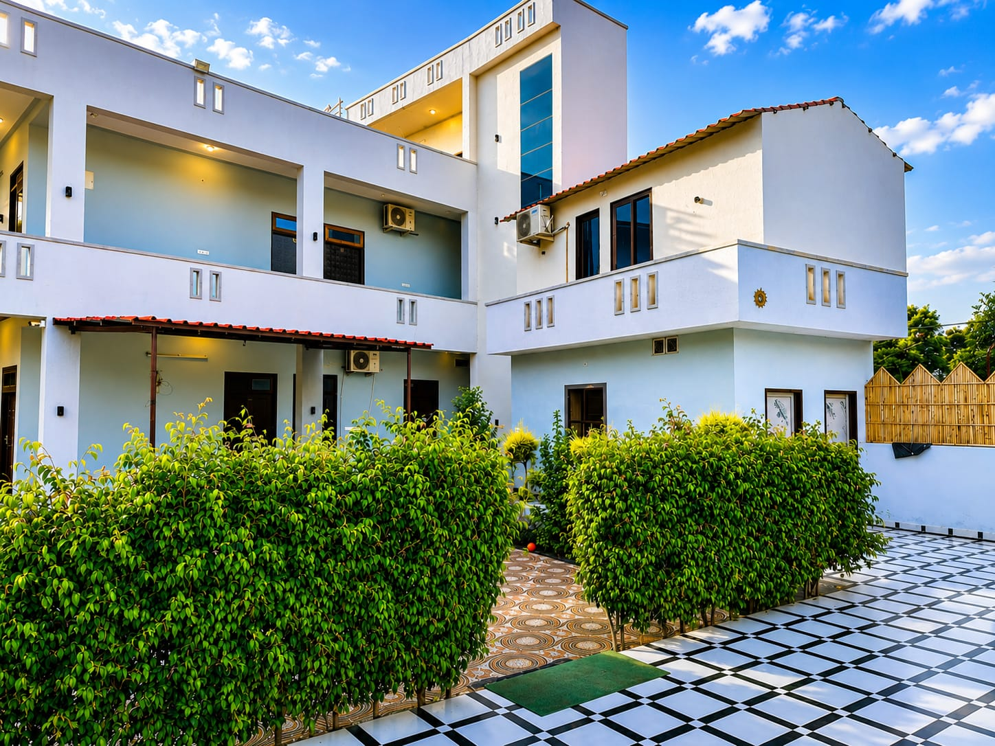 Inner courtyard of the villa with hedged plants and rooms opening onto the garden.